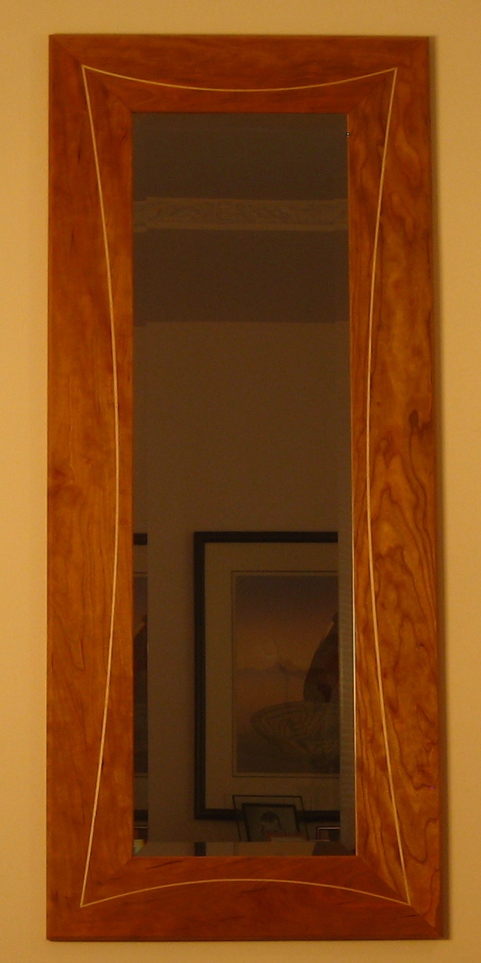 Mirror with curved inlays